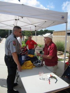 Even Fairfax County Police submit their bike helmets for safety inspection by race volunteers before the Annual Reston Triathlon
