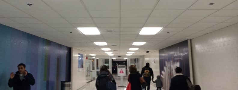 Travelers moving through the halls of the airport.