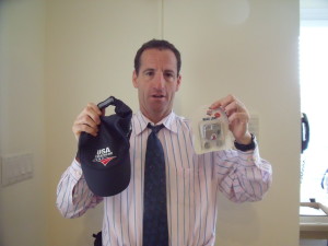 Triathlon Trial lawyer Doug Landau shows off some of the "SWAG" from the USAT National Duathlon Championships, which included such sports safety equipment as a reflective running hat and bicycle light