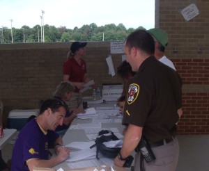 Reston Bicycle accident lawyer, herndon car crash biker accident lawyer, Bike crash injury lawyer and Race Volunteer Doug Landau registering one of the law enforcement participants at the 2010 Reston Triathlon