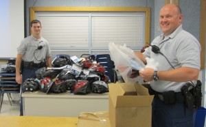 Herndon Bicycle Patrol Police Officers unpacking Bell Helmets to give to Hutchison Elementary School students as part of the bike safety program sponsored by the Herndon law firm ABRAMS LANDAU, the Virginia Trial Lawyers Foundation, and triathlon champion Henry Tragle 