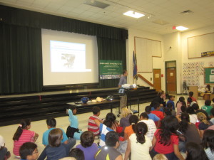 Before giving a new free Bell helmet to each 5th grader at Rolling Ridge Elementary School in Sterling Virginia, Doug Landau teaches the students about brain injury and bike safety