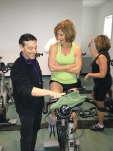 Melissa gets instruction on the GO GREEN FITNESS environmentally friendly indoor spin exercise bike