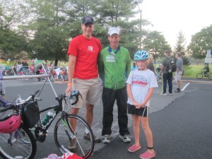 Volunteer, sponsor and sports safety advocate Doug Landau poses with a triathlete and parent who came from Richmond Virginia to participate in the Herndon Kids Triathlon