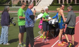 Doug Landau shakes AG winner John Curcio's hand during the awards ceremony after the Winchester Virginia Shenandoah Apple Blossom Festival 10 km. road race 