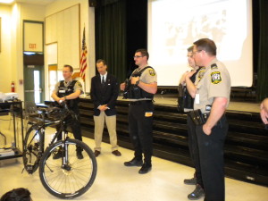 Loudoun County bicycle police join Herndon brain injury prevention lawyer Doug Landau for one of his "Putting the Lids on the Kids" free bike helmet educational programs at the Rolling Ridge Elementary School in Sterling, Virginia