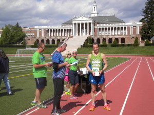 WIth Handley High School in the background, Herndon lawyer Doug Landau collects his prize at the Winchester Virginia Apple Blossom Festival 10km.