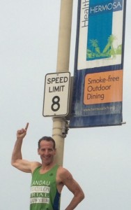 Doug Landau under a 8 mph speed limit sign