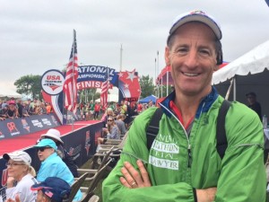 Doug Landau checks out the Olympic Distance race finish from the VIP tent. With a Jumbotron and drones, spectators could see their friends and teammates complete the National Championship course.