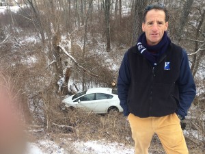 The driver of a small plow truck that was travelling down the road behind Doug Landau stopped and took this picture minutes after the white car came to rest in the gully below.