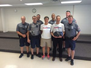 Members of the local police and teacher Connie Peterson, shown here with Doug Landau, know the importance of brain injury prevention.