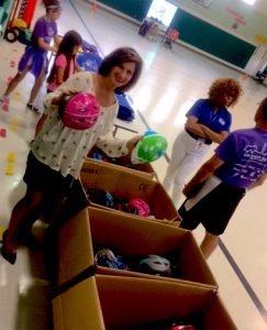 Melissa Landau giving out helmets at Guilford Elementary School May 31, 2017.