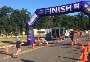 One of the youngsters that raced with his swim cap on heads to the finish line !