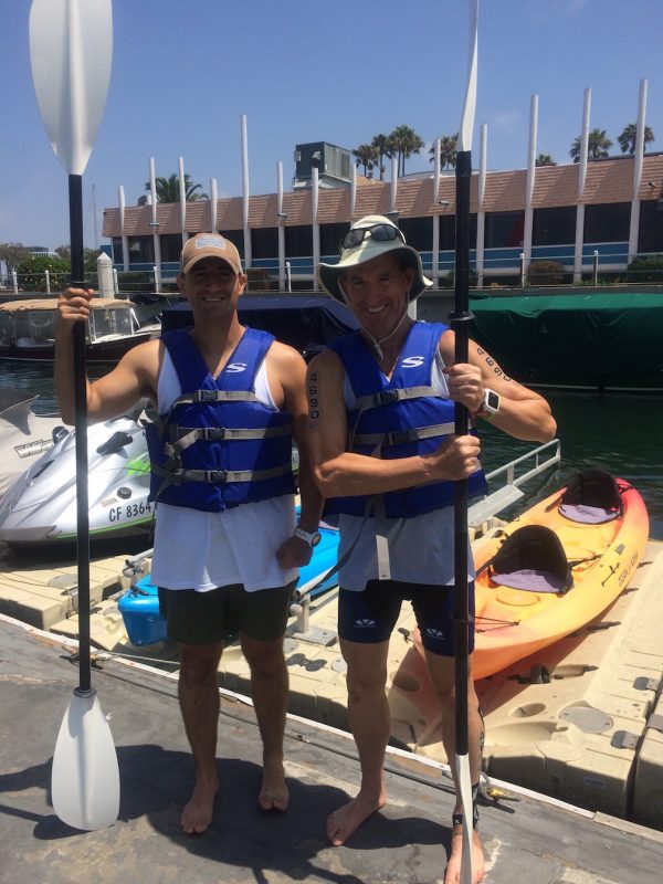 Lt. Zach Landau, USN, about to show his dad how to navigate a 2-person kayak