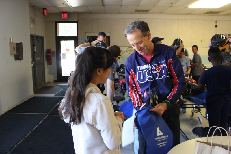 doug landau giving away bike helmet at clearview elementary school