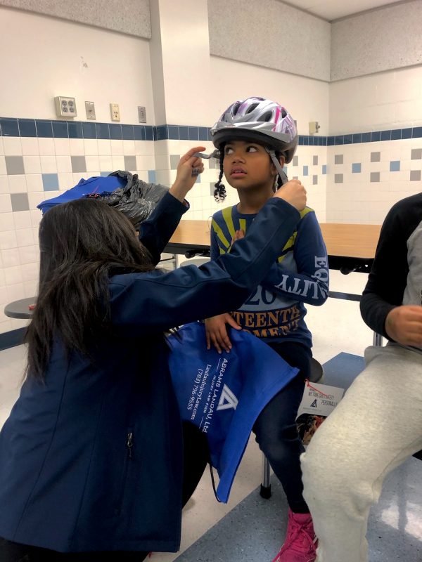 Fitting a helmet on student