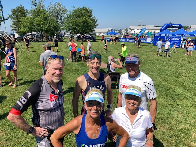 Kinetic Multisports Volunteer oordinator Janie Langford (foreground) does a great job.(L-R) Behind her and her mother, CBC Triathlon Coach Rob Colburn, Race Sponsor Doug Landau, and Team USA member (& perennial AG champ) Tom Stroup are all smiles