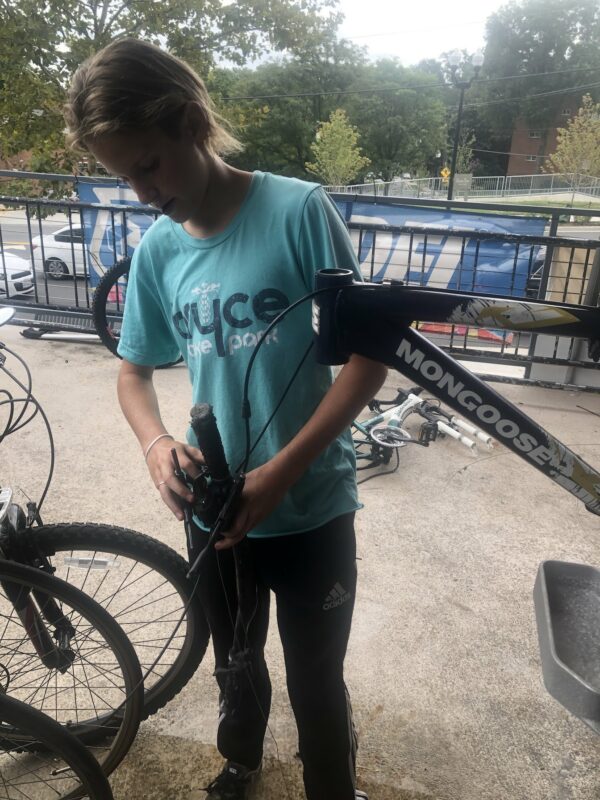 young bike mechanic stripping bike of parts