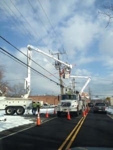 Power company trucks repairing downed power lines