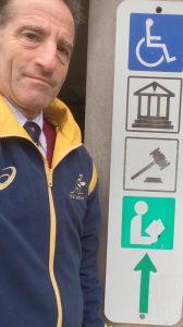 In some fatal workplace accident cases, there may be more than one person who can receive the workers comp death benefits. Herndon injury lawyer Doug Landau, shown here by the sign for the Herndon Courthouse, Library, Municipal Center & Handicapped Parking has successfully tried several such fatality cases.