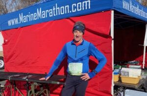 Attorney Doug Landau poses in front of a medical tent at the Marine Corps Marathon