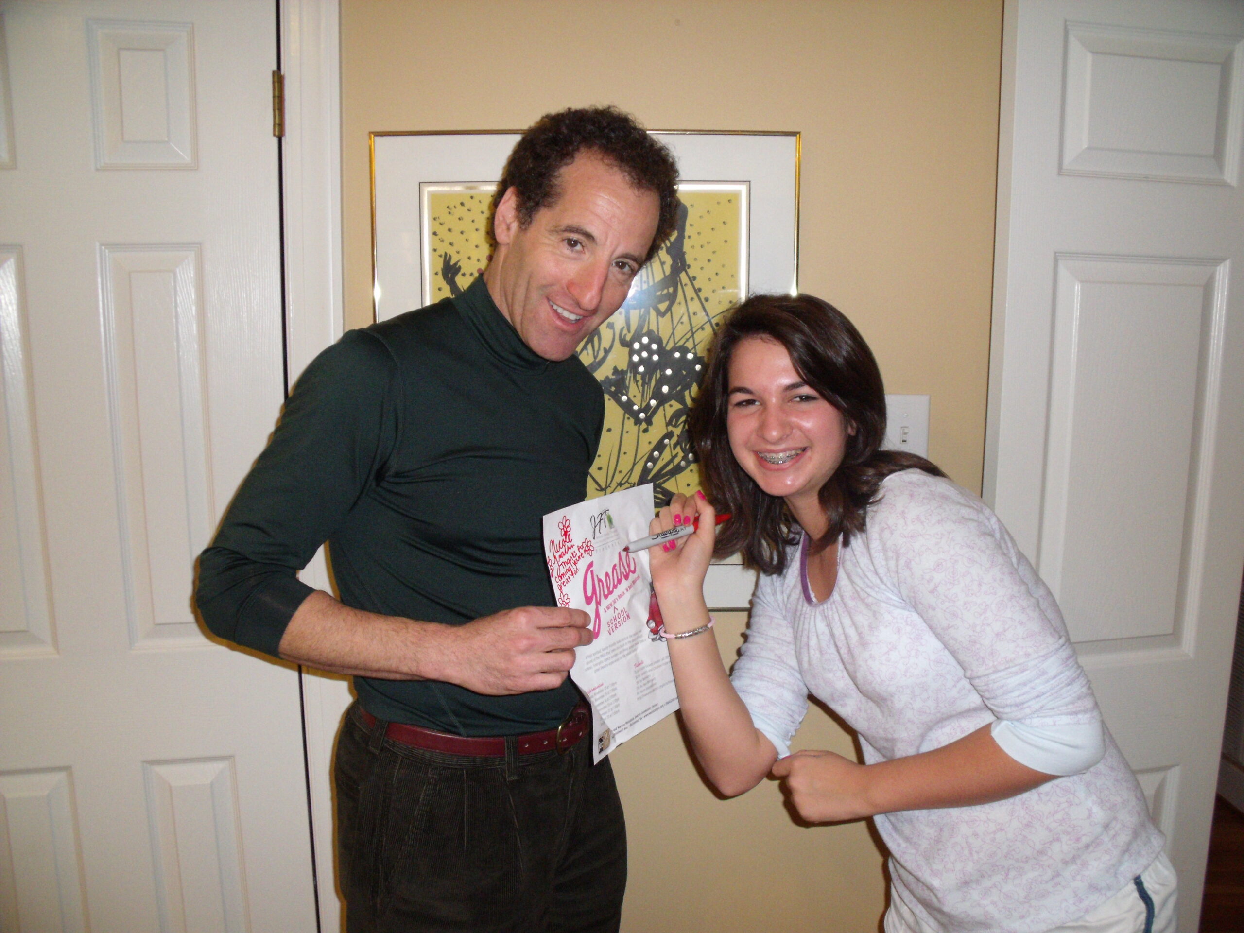 Wellesly Hills 5k race director Nicole Fratkin signs her autograph for her fan Doug Landau