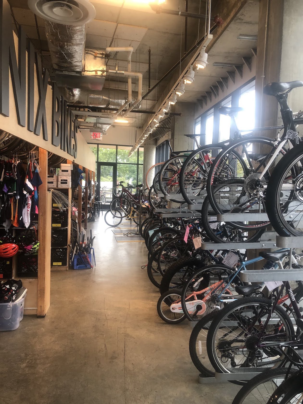 Interior of the Phoenix Bikes bike shop, showing lineup of many completed or in-progress bikes
