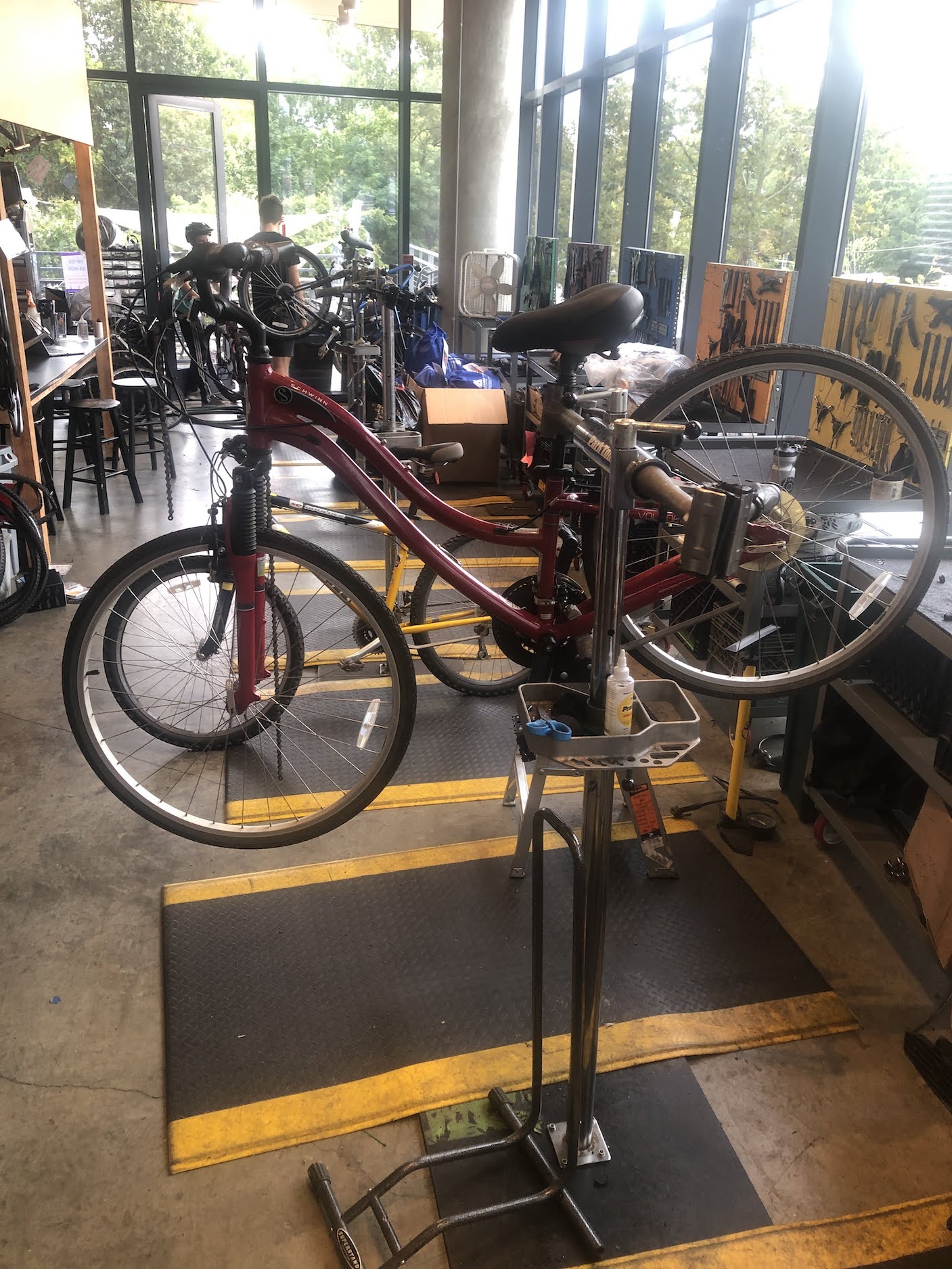 A bicycle clamped in the air at a work station