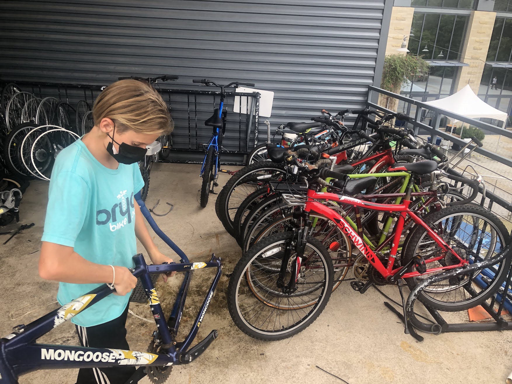Aelin, young mechanic in Earn-a-Bike program for Phoenix Bikes, stripping bikes of parts