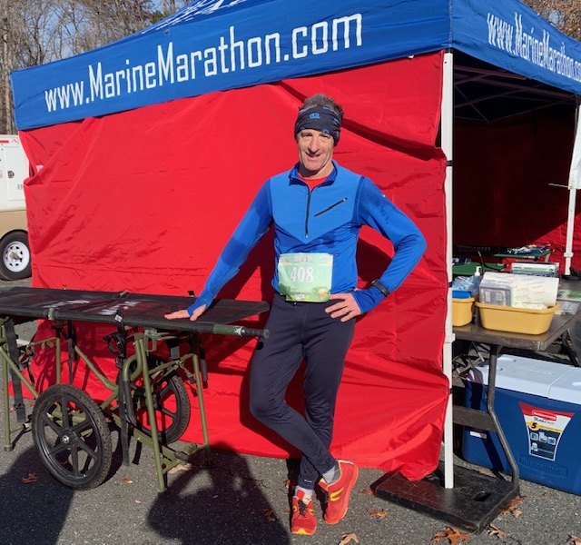 Attorney Doug Landau poses in front of a medical tent at the Marine Corps Marathon
