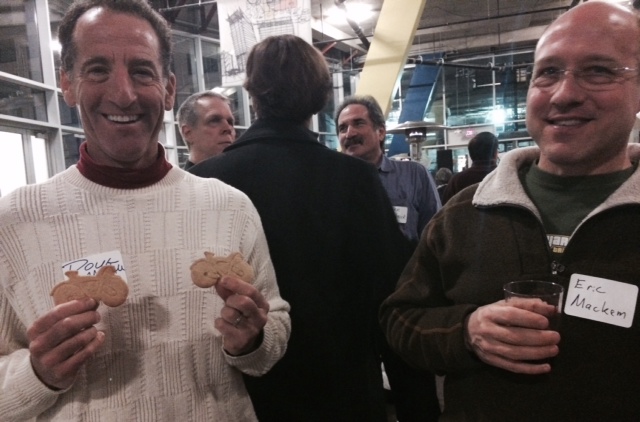 Herndon bike lawyer Doug Landau enjoys the cycle cookies as Lifetime Fitness indoor triathlon champion Eric Mackem of Reston samples some of the local brewery’s offerings.